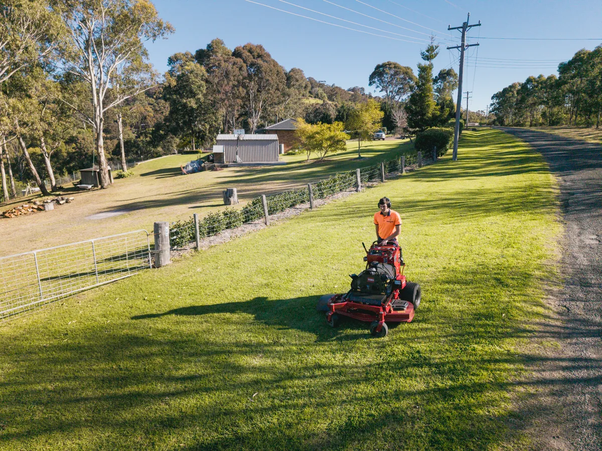 Acreage property being mowed by a Keeping It Green ride-on mower