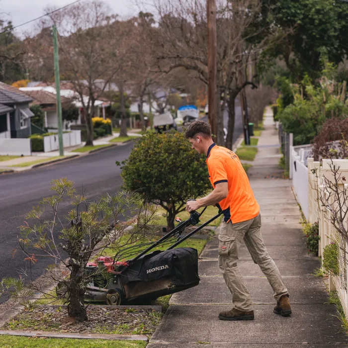 Lawn mower being pushed by a Keeping It Green team member in Camden NSW