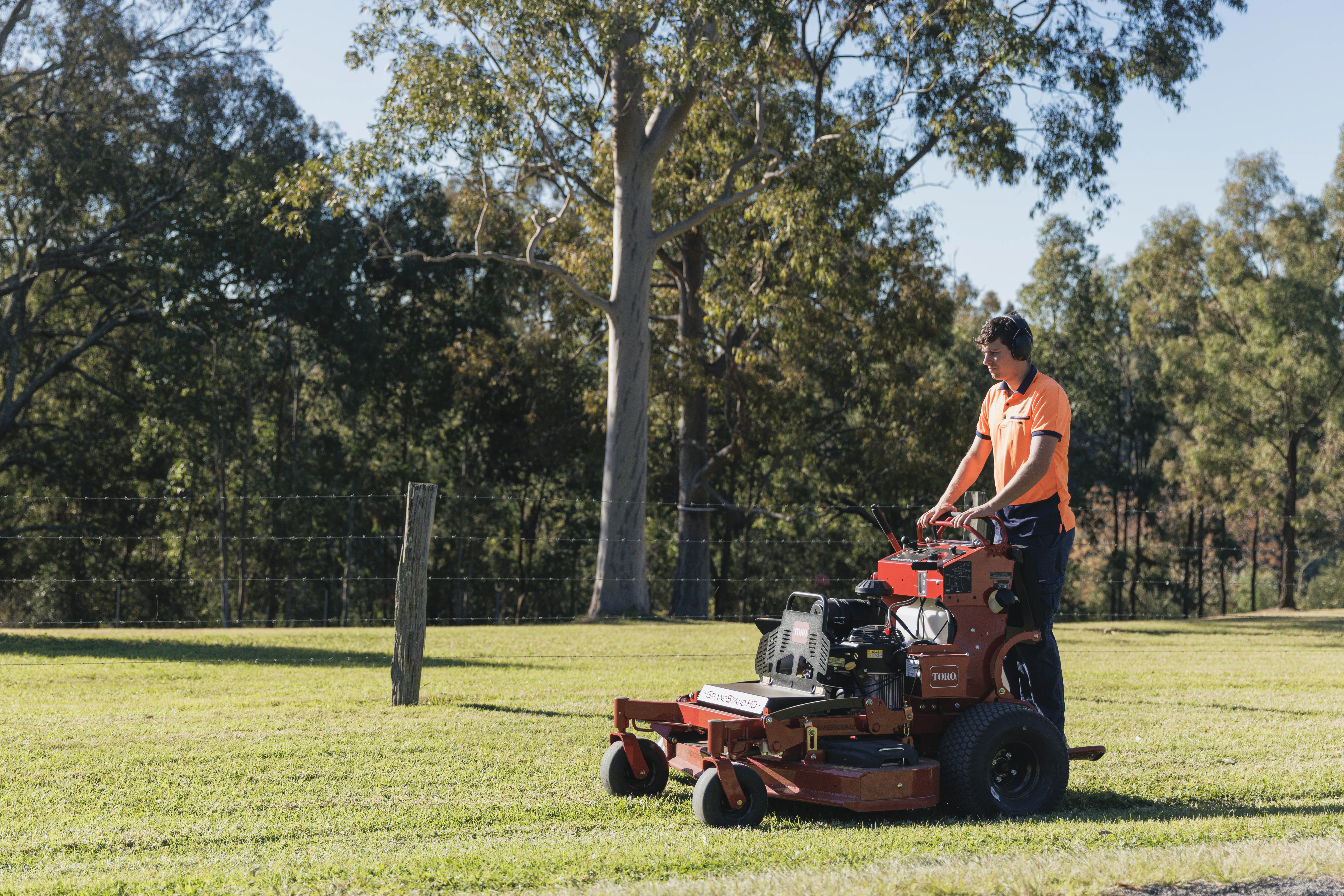 Keeping It Green operator mowing an acreage paddock on a Toro stand-on ride-on mower