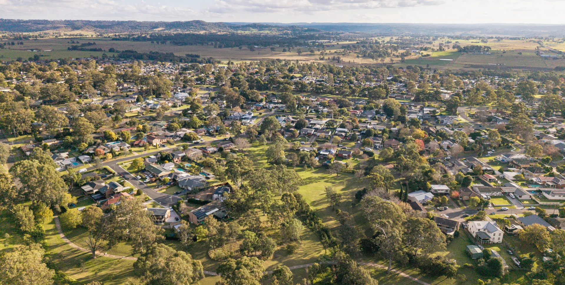 Aerial view of Camden South showing established homes, mature trees and surrounding farmland