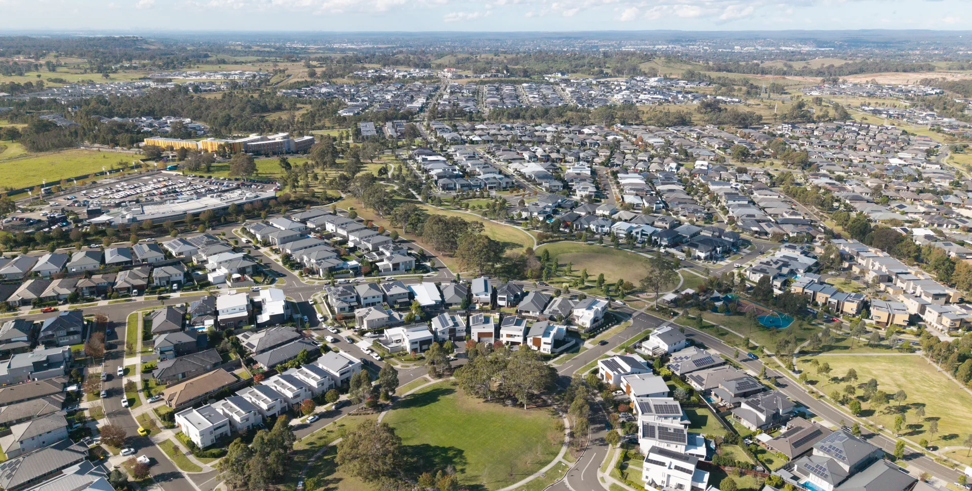Aerial view of a Camden residential estate with homes, parks and tree-lined streets