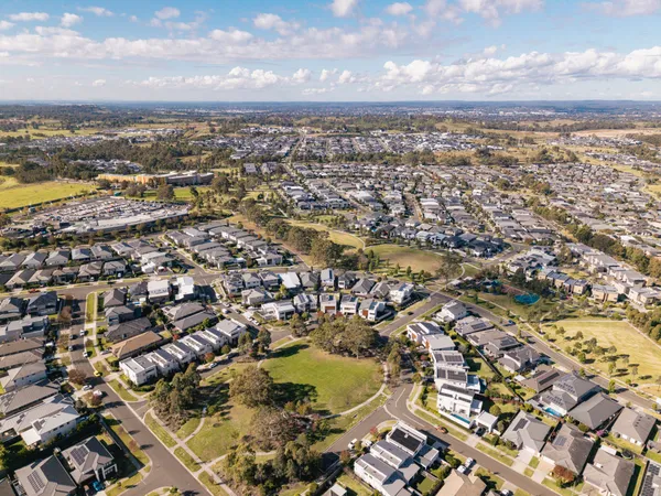 Aerial view of Gledswood Hills showing new estate homes, parkland and the local shopping centre
