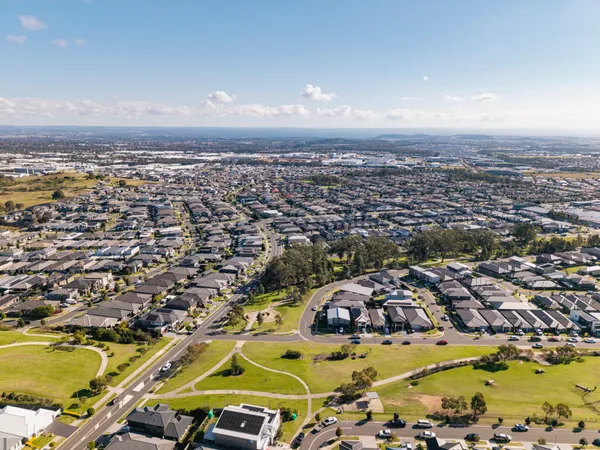 Aerial view of Gregory Hills showing new estate homes, parkland and the nearby business park
