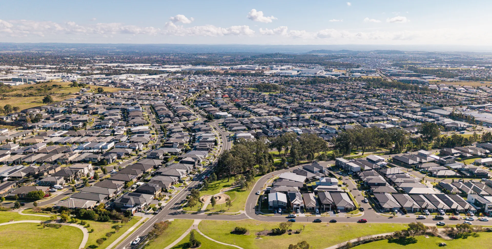 Aerial view of Gregory Hills showing new estate homes, parkland and the nearby business park