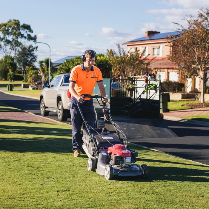 Lawn mower being pushed by a Keeping It Green team member in Camden NSW